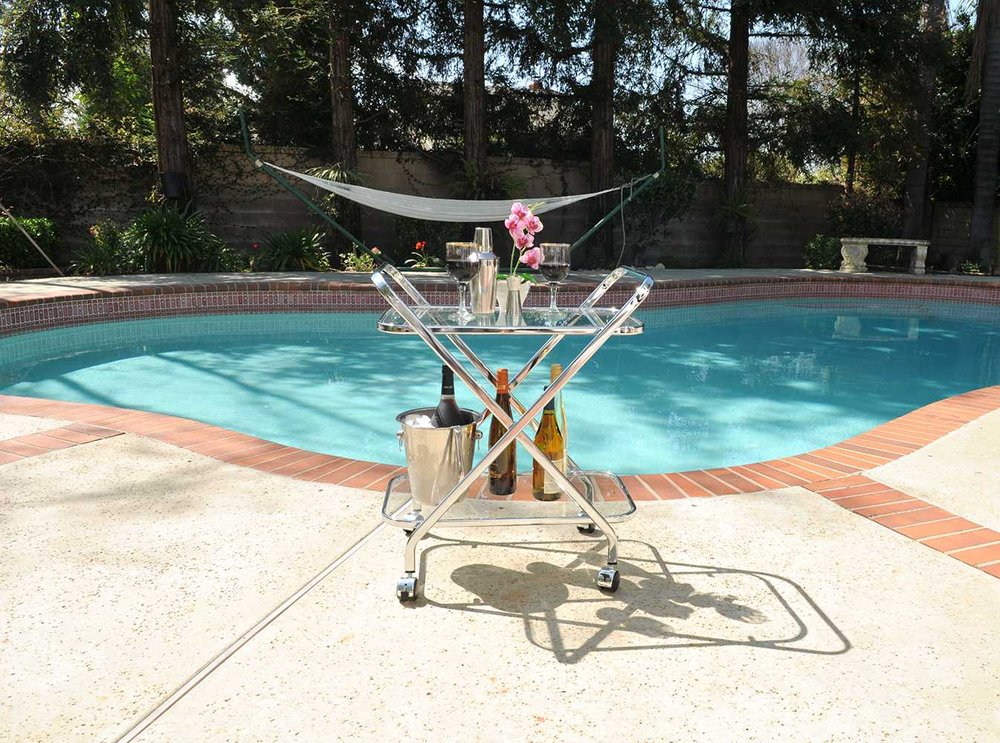 26" Silver Metal and Glass Rolling Bar Cart HomeRoots