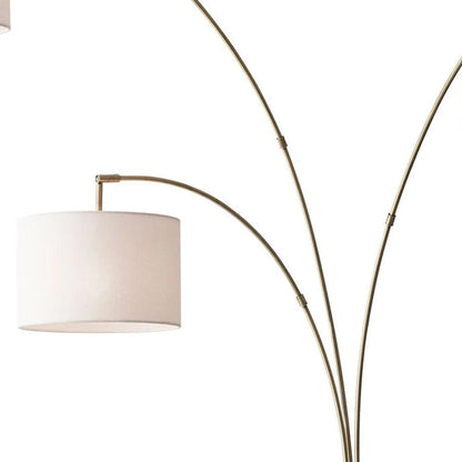 74" Brass Three Light Arc Floor Lamp With Off White Fabric Drum Shade HomeRoots
