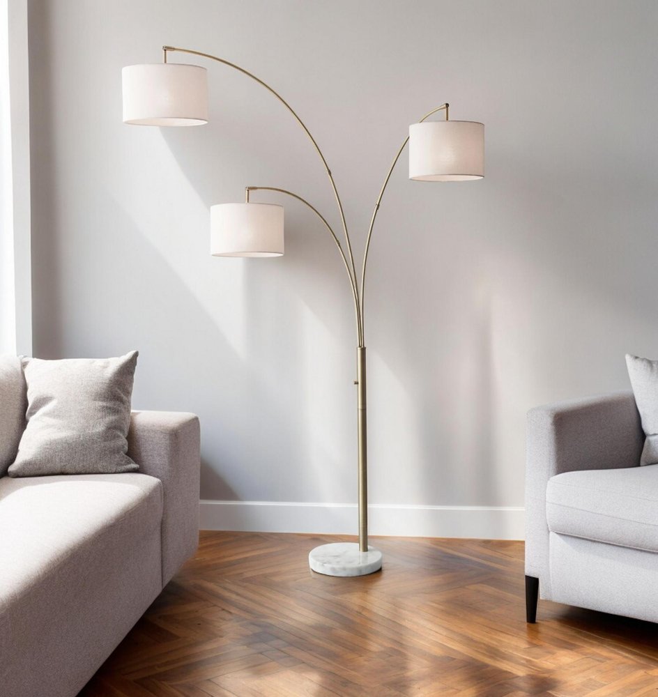 74" Brass Three Light Arc Floor Lamp With Off White Fabric Drum Shade HomeRoots