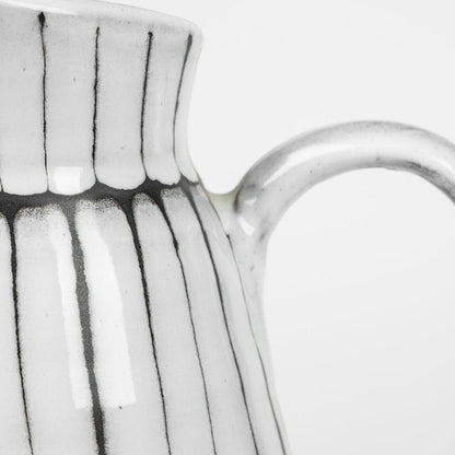 13" Black And White Ceramic Cylinder Jug Vase With Sculptural Details HomeRoots