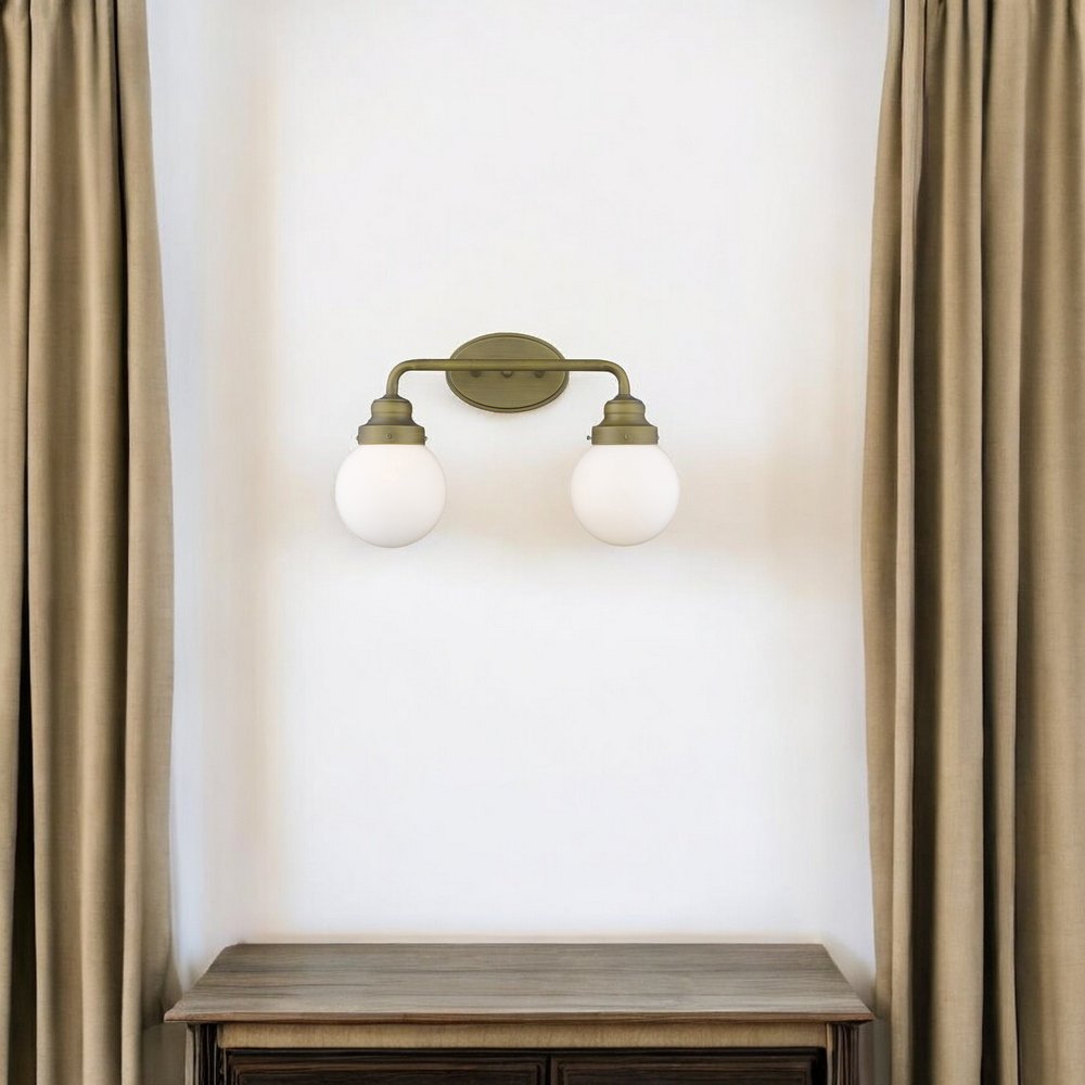 Two Light Gold Wall Sconce with Round Glass Shade HomeRoots
