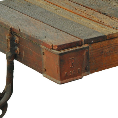 50" Brown and Black Solid Wood and Iron Distressed Wheel Coffee Table HomeRoots