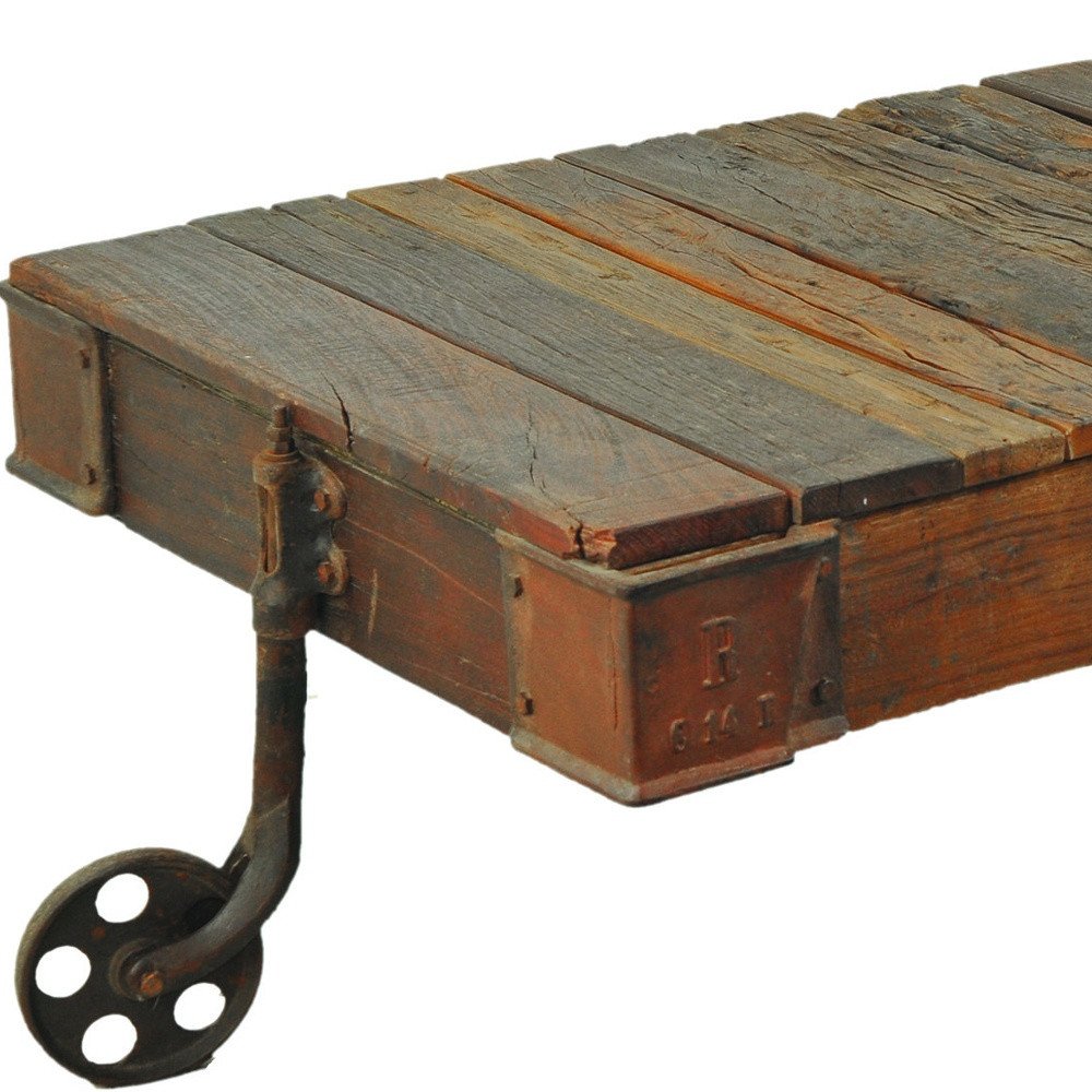 50" Brown and Black Solid Wood and Iron Distressed Wheel Coffee Table HomeRoots