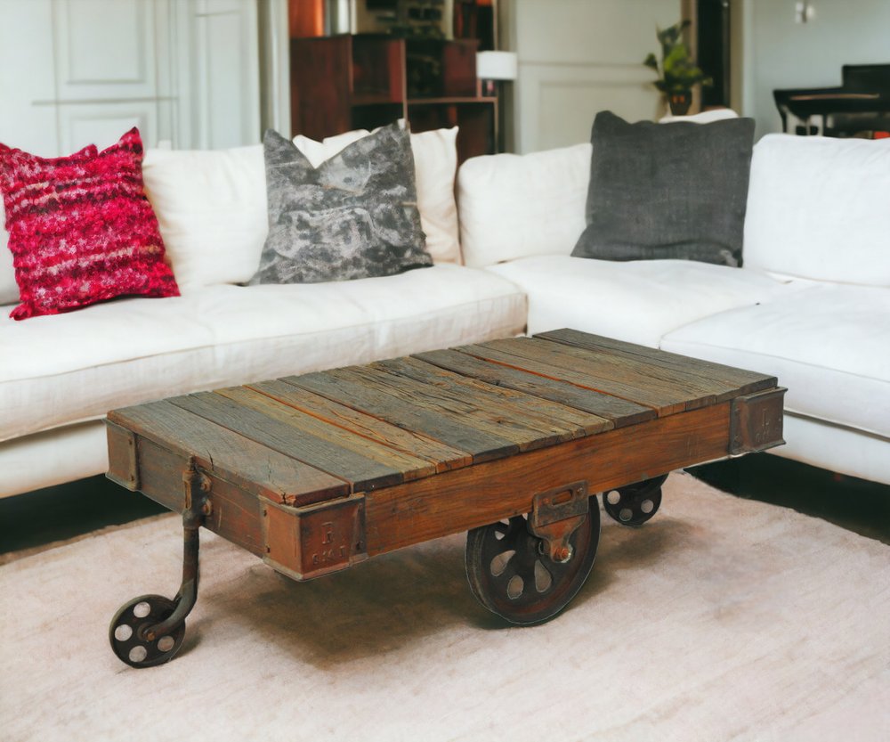 50" Brown and Black Solid Wood and Iron Distressed Wheel Coffee Table HomeRoots