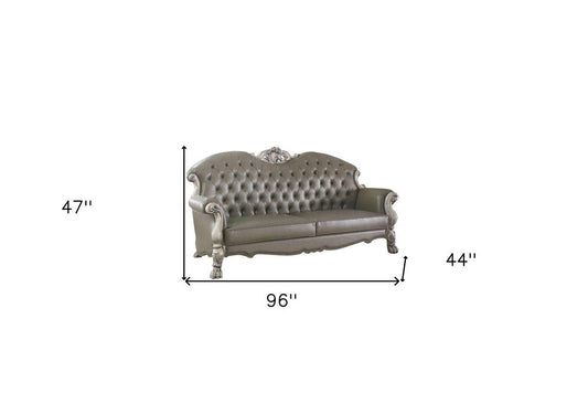 96" Bone Faux Leather Sofa And Toss Pillows With White Legs HomeRoots