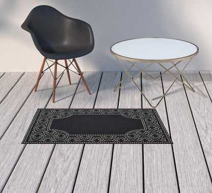 2' X 4' Black and Ivory Stain Resistant Indoor Outdoor Area Rug