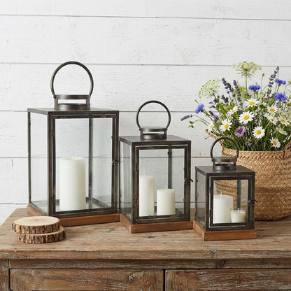 Set of Three Gray And Brown Distressed Geometric Glass Metal And Wood Floor Lantern Candle Holders HomeRoots