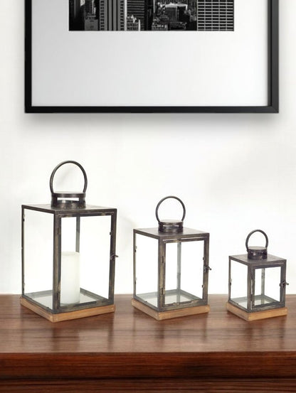 Set of Three Gray And Brown Distressed Geometric Glass Metal And Wood Floor Lantern Candle Holders HomeRoots