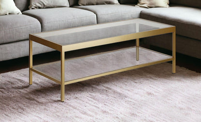 45" Clear Glass And Gold Steel Coffee Table With Shelf - FurniFindUSA