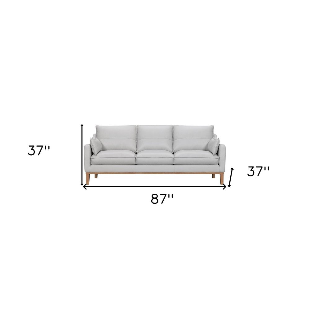 87" Gray Leather Sofa And Toss Pillows With Brown Legs HomeRoots