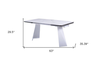 63" White Ceramic and Metal Self-Storing Leaf Pedestal Base Extendable Dining Table HomeRoots