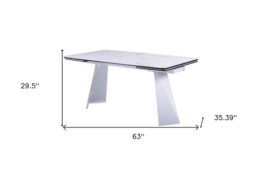 63" White Ceramic and Metal Self-Storing Leaf Pedestal Base Extendable Dining Table HomeRoots