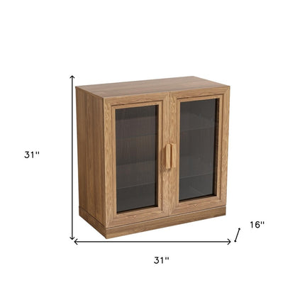 31" Natural And Clear Glass Door Accent Cabinet With Three Shelves HomeRoots