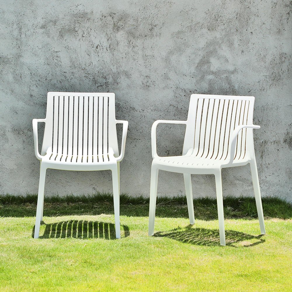 Set of Two White Heavy Duty Plastic Outdoor Stacking Arm Chairs HomeRoots