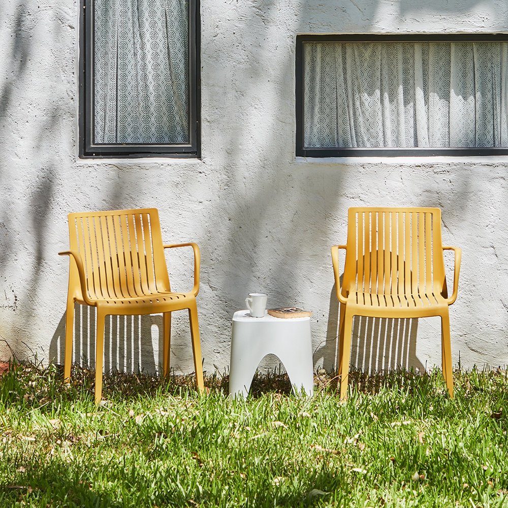 Set of Two Yellow Heavy Duty Plastic Outdoor Stacking Arm Chairs HomeRoots