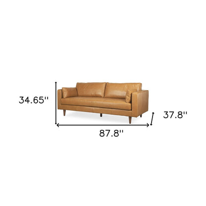 88" Tan Leather Sofa And Toss Pillows With Brown Legs HomeRoots