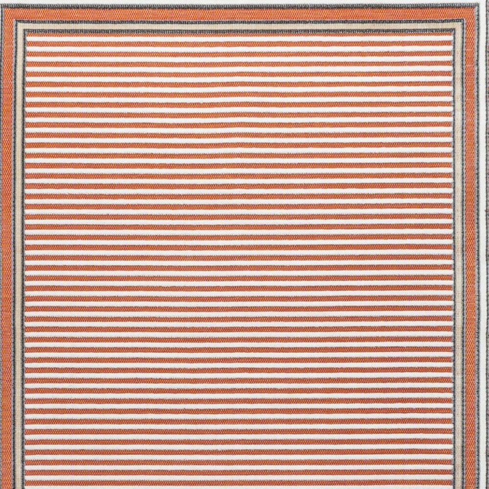 5' X 8' Orange And Ivory Geometric Indoor Outdoor Area Rug