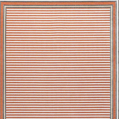 5' X 8' Orange And Ivory Geometric Indoor Outdoor Area Rug
