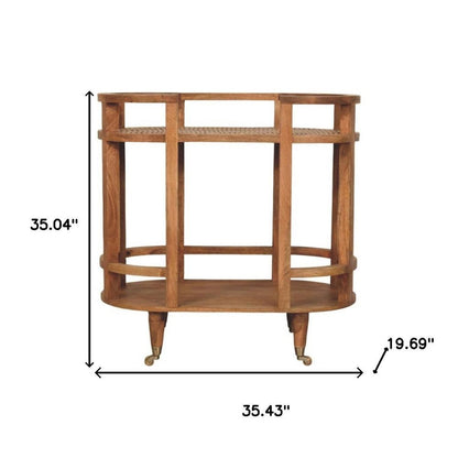 35" Golden Brown Rattan and Solid Wood Oval Wheel Console Table With Shelf HomeRoots