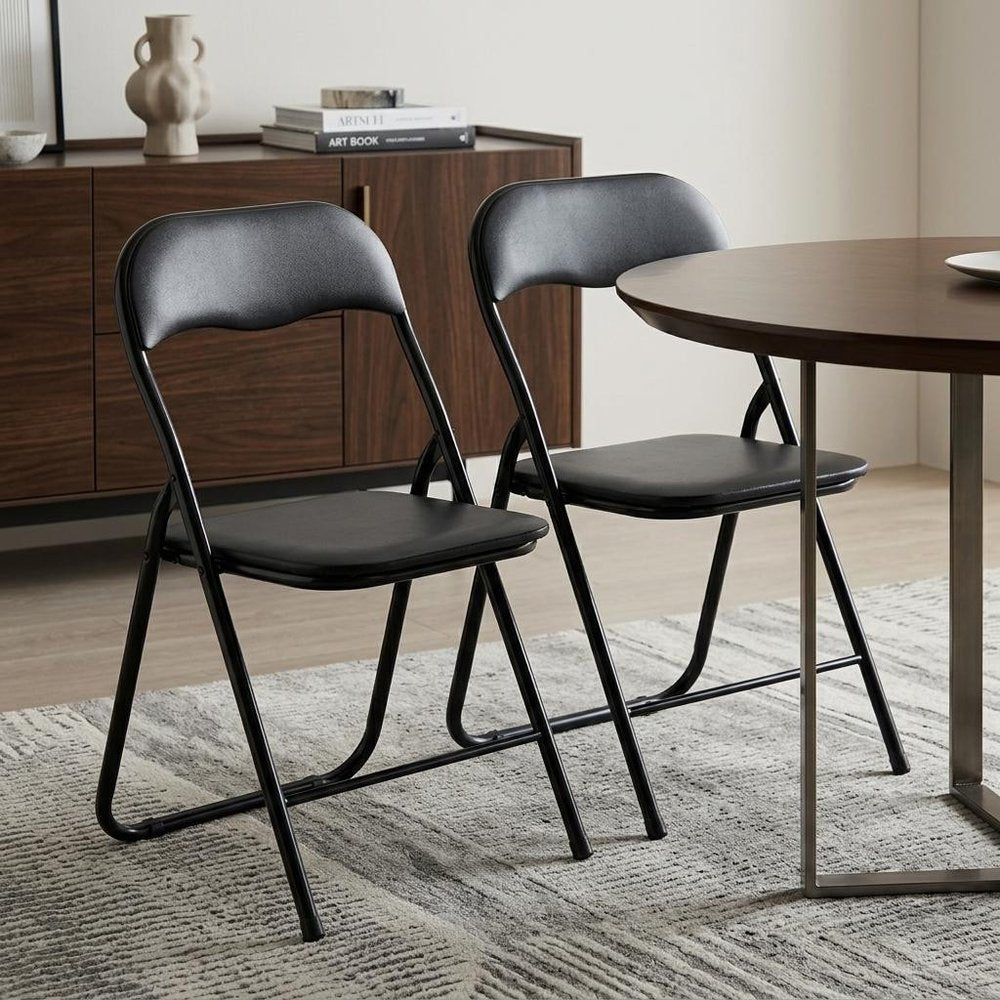 Set of Two Black Faux Leather and Steel Folding Chairs HomeRoots