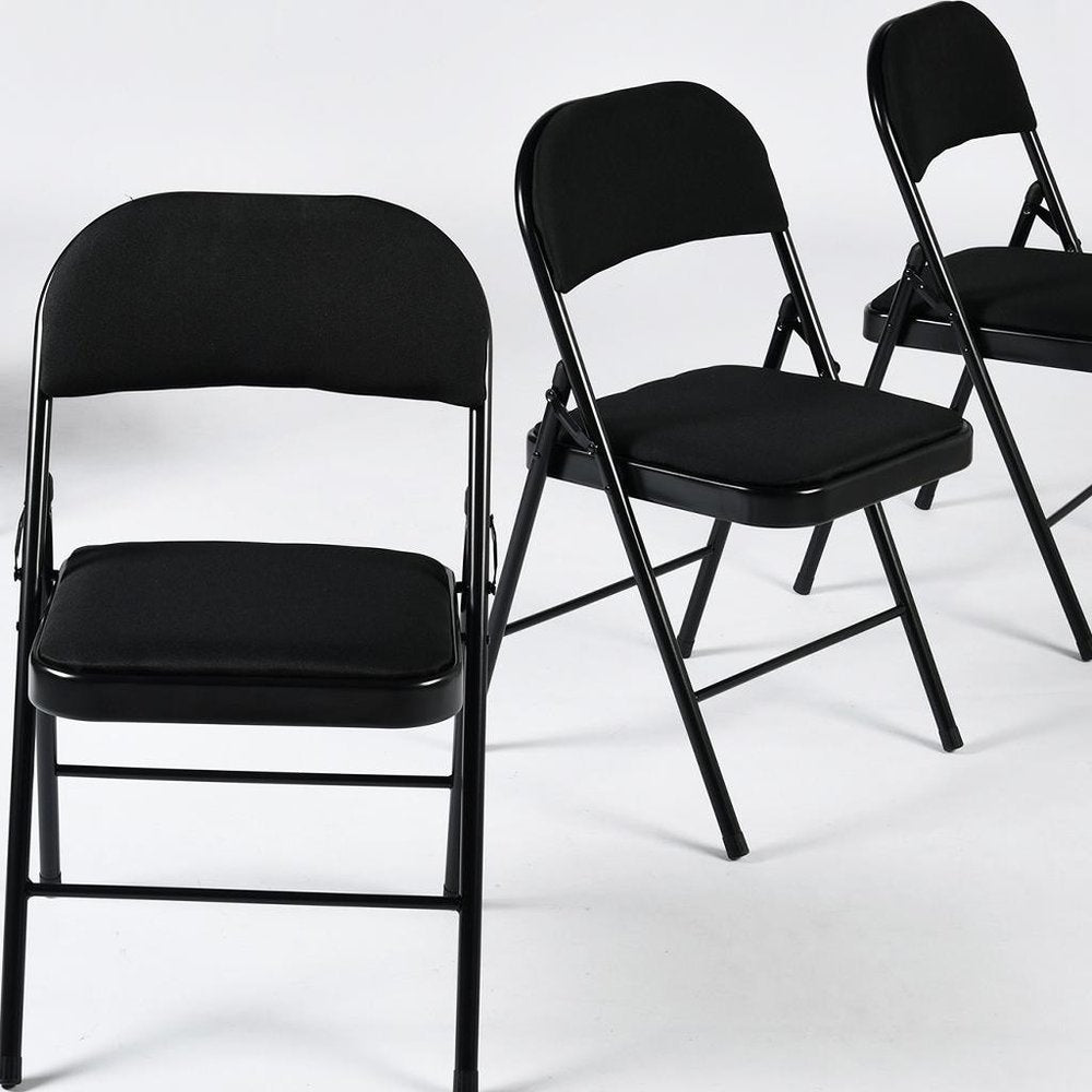 Set of Four Black Faux Leather and Steel Folding Chairs HomeRoots