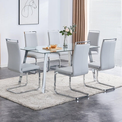 A modern minimalist rectangular glass dining table with tempered glass tabletop and silver metal legs - FurniFindUSA